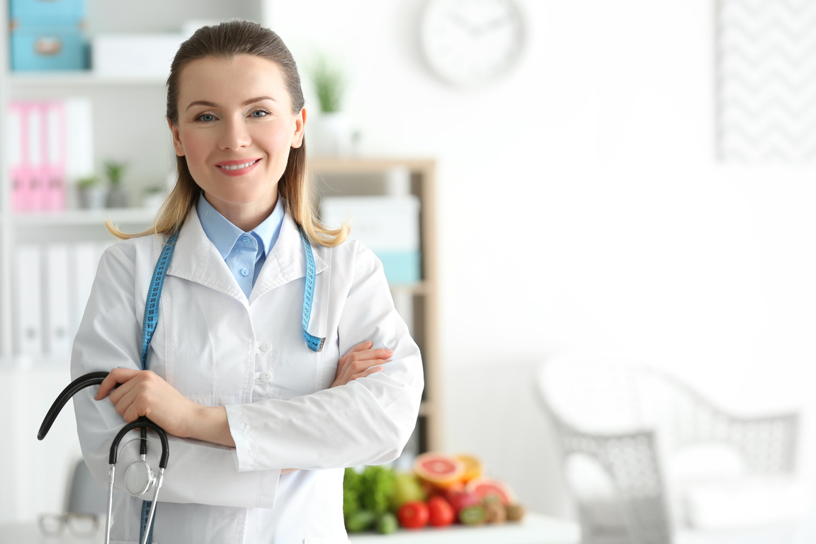 Female Nutritionist Standing in Her Office
